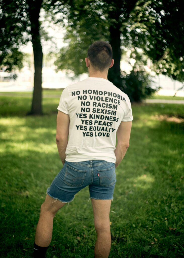 Back view of a man in a park advocating love and equality on a T-shirt.